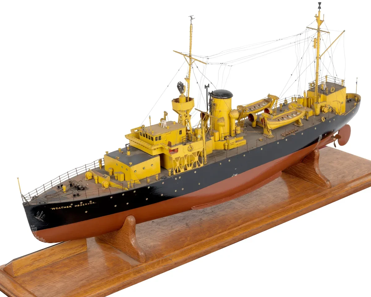 A ship model of Ocean Weather Ship Weather Observer. The top of the ship, including the funnels, masts and deck, are painted bright yellow 